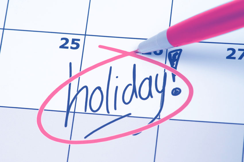 An image of a calendar that has the word Holiday! on top of the 26th of the calendar.